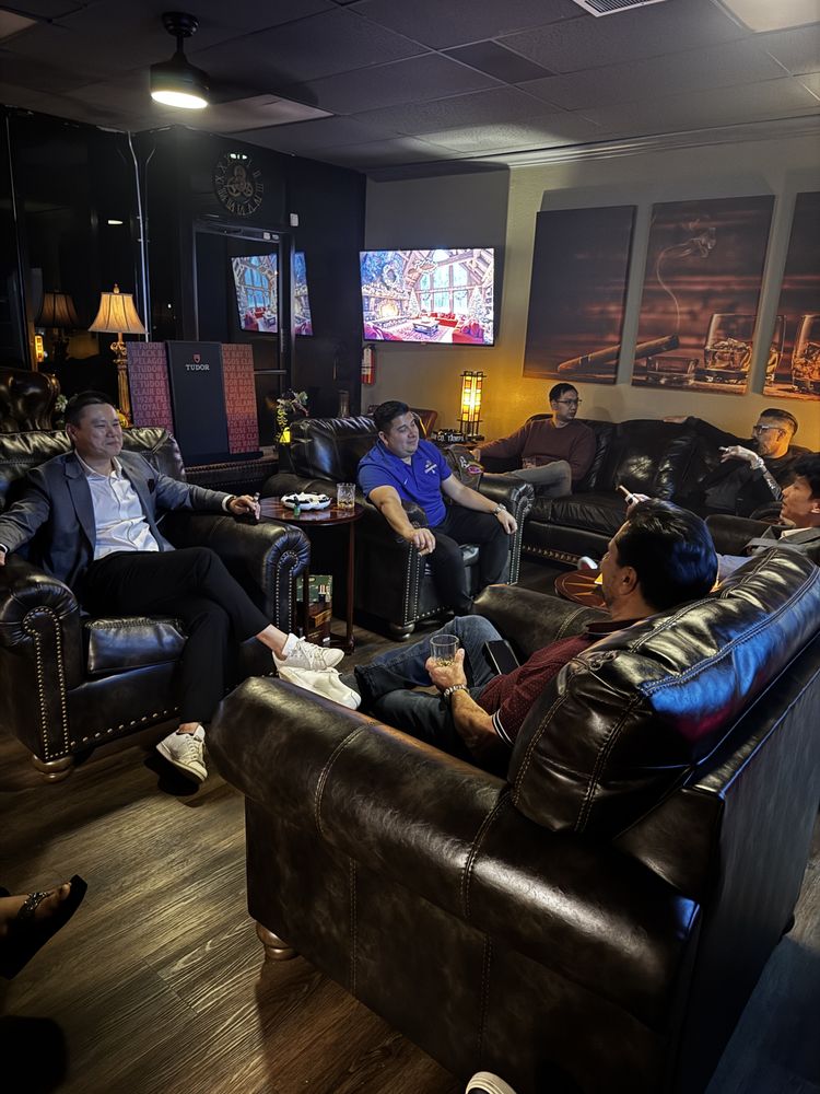 Members relaxing on leather sofas in the Cigar Haus lounge while enjoying cigars