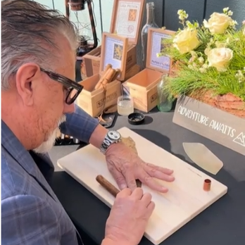 Rod rolling a cigar at an event table